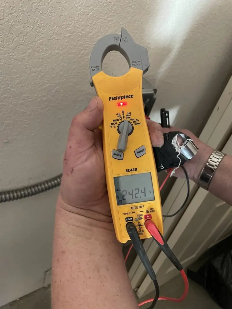 Voltage testing with clamp meter during Outlet Installation in Wisconsin Dells